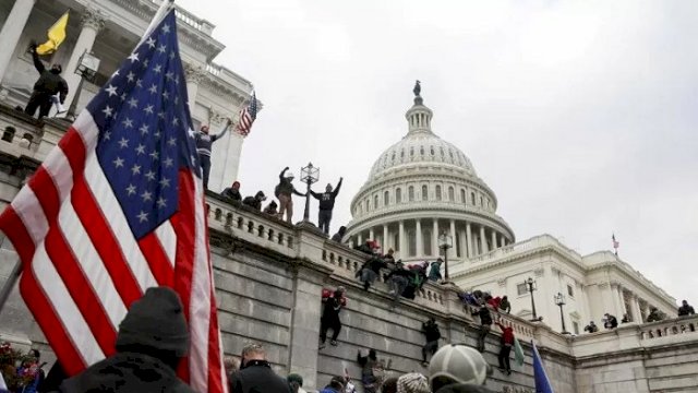 Pendukung Presiden AS Donald Trump memanjat tembok Gedung Capitol saat protes terhadap sertifikasi hasil pemilihan presiden Amerika Serikat 2020 oleh Kongres AS di Washington, Amerika Serikat, Rabu (6/1/2021). ANTARA FOTO/REUTERS/Jim Urquhart/rwa.