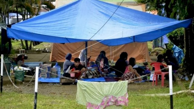 Warga korban gempa bumi mengungsi di halaman Rumah Sakit Umum Kabupaten Mamuju di Sulawesi Barat, Minggu (17/1/2021). Sebanyak 27.850 jiwa telah mengungsi di sejumlah posko pengungsian karena rumah mereka rusak akibat gempa bumi berkekuatan magnitudo 6,2 yang terjadi pada Jumat (15/1) dini hari yang juga mengakibatkan 73 orang meninggal dunia. ANTARA FOTO/Abriawan Abhe.